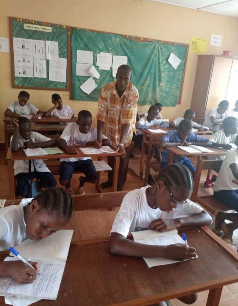 Mr. Muhammad Lamin Ceesay in class at Notre Dame School Soma