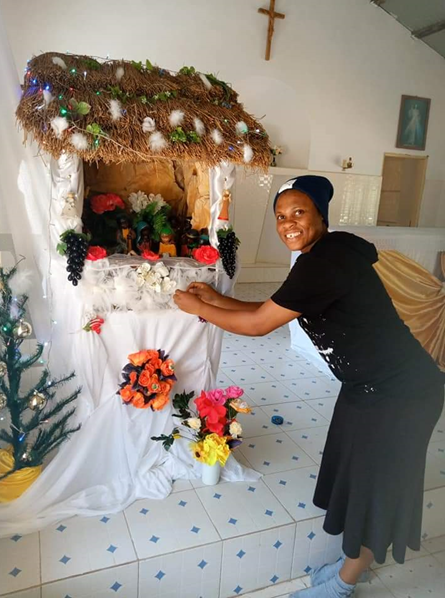 Sister Maryanne decorating the manger in the Church of Our Lady of Fatima