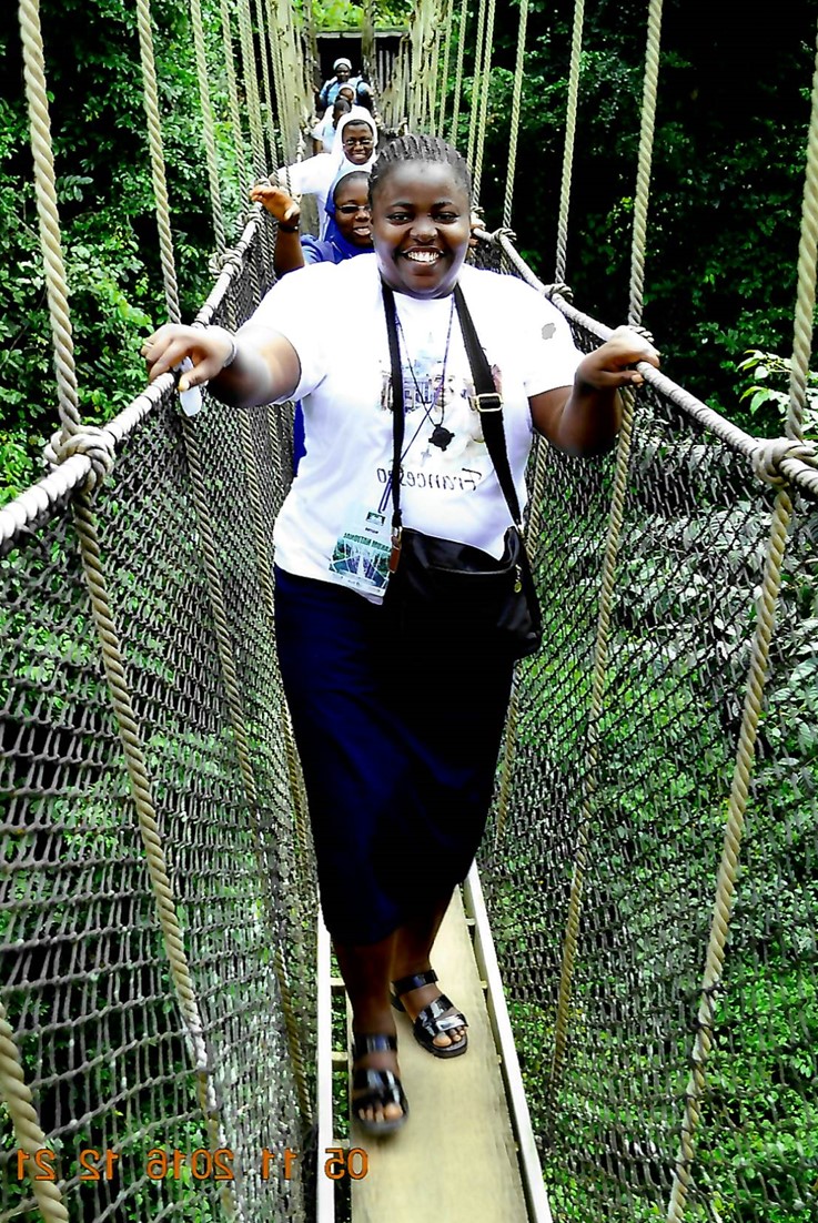 Sister Gloria Adoga crossing swinging bridge