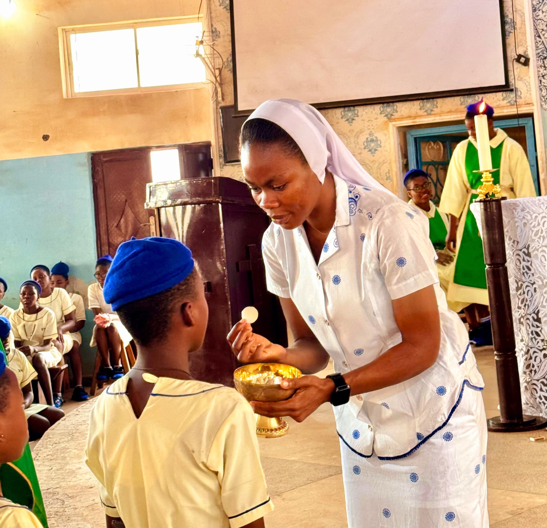 Sister Beatrice Ortserga distributing communion