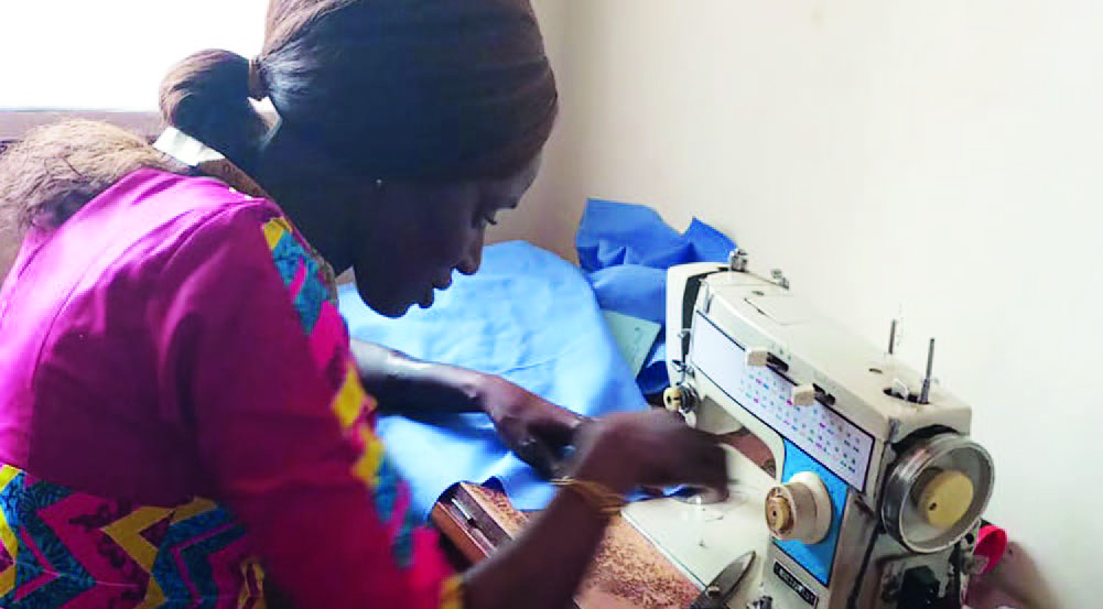 Martha Mendy sewing a garment - story from In Mission 2023